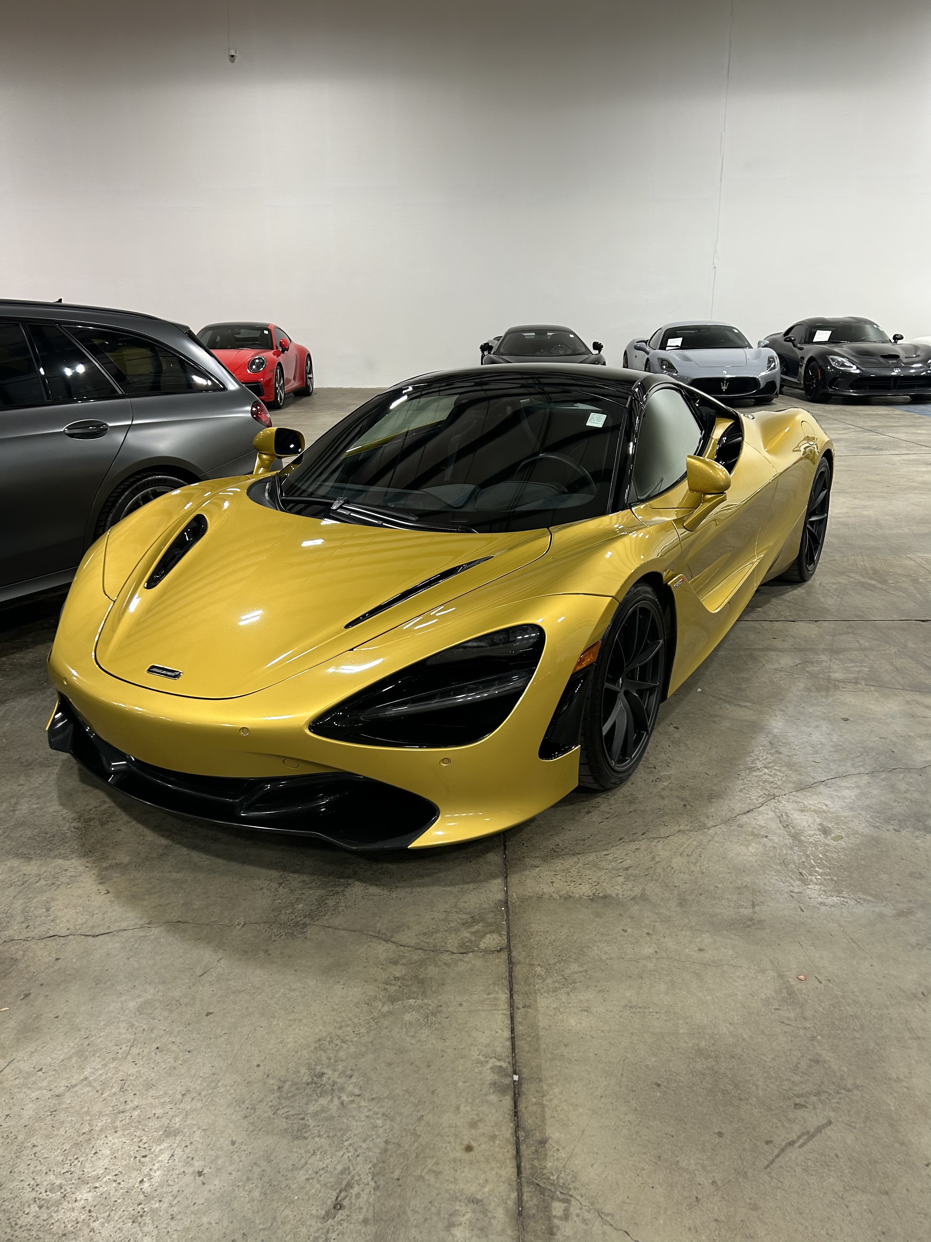 McLaren 720S completed on-site at Sarchione Auto Gallery's warehouse, with other dealer inventory visible in the background - evidence of Burton's embedded on-site dealer work.
