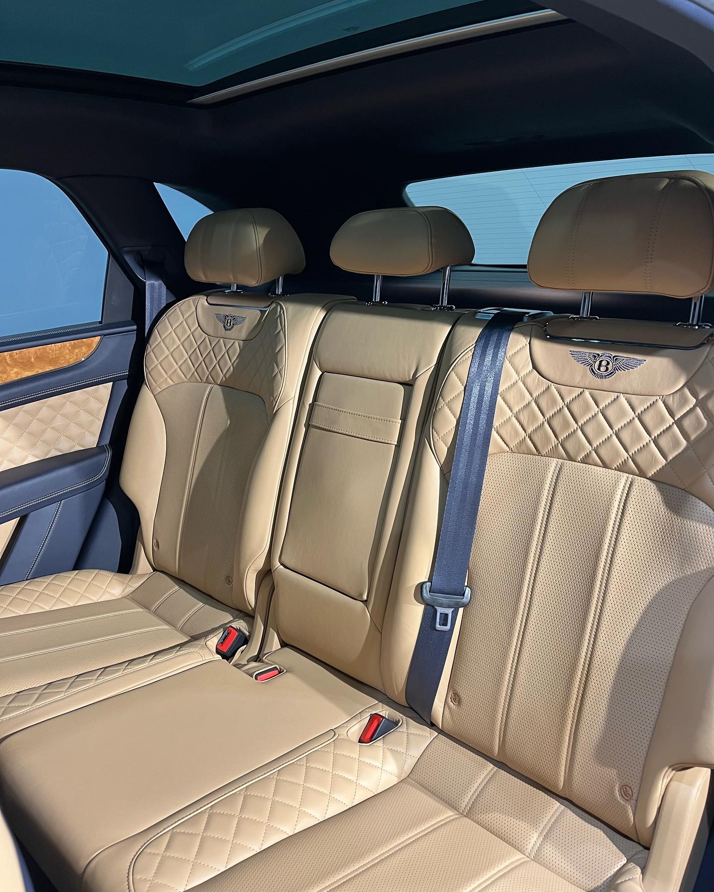 Bentley Bentayga rear cabin with panoramic roof and tan diamond-quilted seats